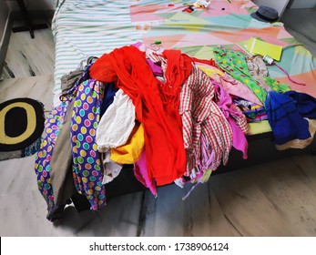 Messy Bed Room Interior With Pile Of Clothes. Focus On Clothes.