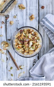 Messy Bowl Of Vegan Keto Granola Made With Pecans, Hazelnuts, Unsweetened Coconut, Sunflower Seeds, Pepita Seeds And Sweetened With Erythritol. Served With Low Carb Almond Milk. Top View Or Flatlay.