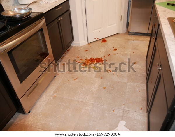 shattered glass on the floor with blood