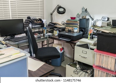 Messy Business Office Desk With Boxes Of Files And Disorganized Clutter.