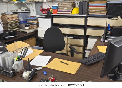 Messy, Busy Desk In A Warehouse Back Office.