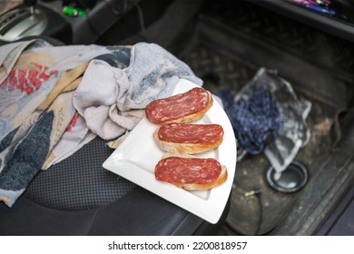 A Messy Car Interior With Sandwiches On The Front Seat