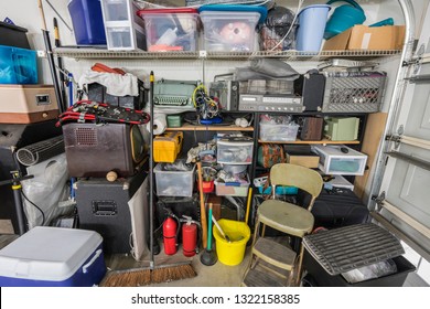 Messy Cluttered Garage Shelves With Vintage Electronics, Housewares And Sports Equipment.  