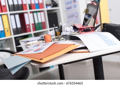 Messy And Cluttered Office Desk