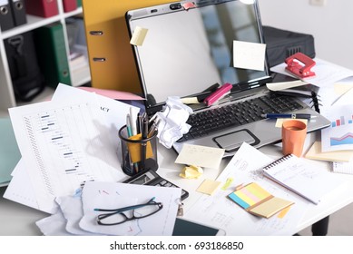 Messy And Cluttered Office Desk