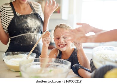 Messy but delicious. Shot of two little girls having fun while baking with their mother in the kitchen. - Powered by Shutterstock