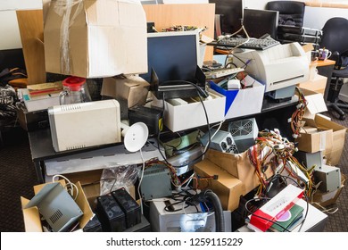 A Messy Desktop With Stacks Of Files And Other Documents, All Kind Of Office Supplies And Part Of A Keyboard And Pc.