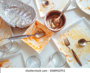 Messy Dining Table And Crockery After Lunch By Many People. No People, Still Life, Table Top Image Shot From Top Angle In Natural Light In A Restaurant.