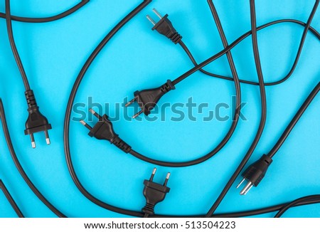 Messy of electrical cords plug and wires unconnected top view on colorful background, messy electric equipment flat lay concept.