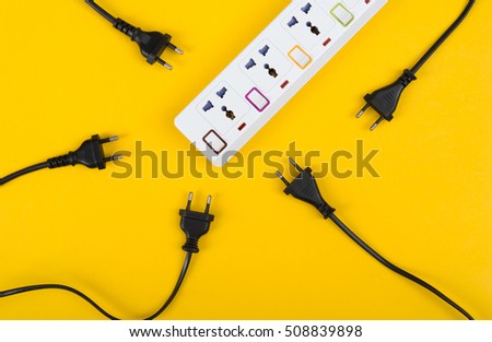 Messy of electrical cords and wires unconnected electrical power strip or extension block  with messy wires, top view on colorful background, messy electric equipment flat lay concept.