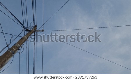 messy electrical wires under the blue sky