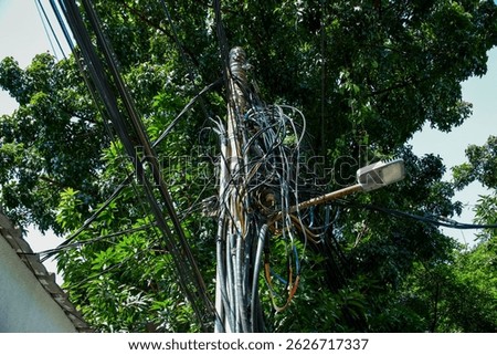 messy electricity wires on the pole, The chaos of cables and wires on an electric pole in Jakarta