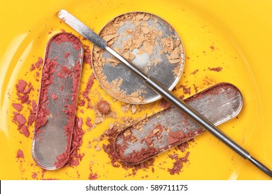 Messy Empty Metallic Containers Of Destroyed Makeup Products Such As Face Powder, Blusher And Eyeshadow On Bright Yellow Background. Top View Point.