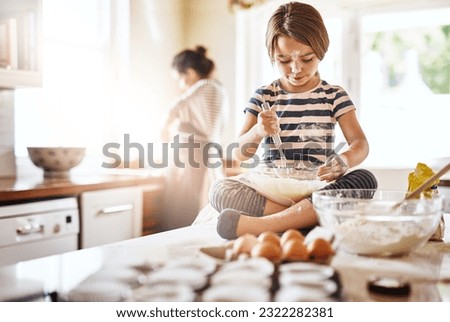Messy, flour and girl baking in a kitchen with parent for learning about Independence, child development or food at home. Dirty, fun or young female kid mixing cake or cookies in a bowl while cooking