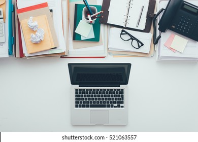 Messy Full Desktop Opposing A Tidy Clean Desktop, Piles Of Paperwork On Top And A Laptop At Bottom, Business And Technology Concept