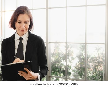 Messy Hair Businesswoman Wears Black Suit And Necktie Standing Writing Note. Portrait Of Beautiful Middle Aged Professional Executive Woman Busy Working Uncombed Hair. Confident Female Untidy Head.