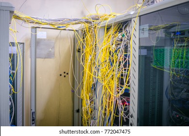 Messy Internet Wires Have A Connection To Computer Servers. Cabinets With Computer Equipment Are Located In The Data Center. Racks With Servers Are Located In The Server Room