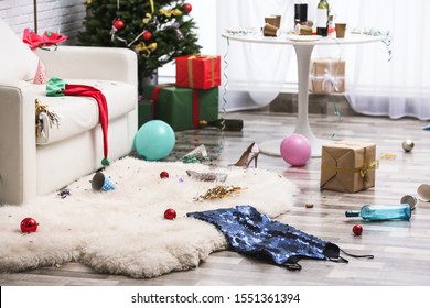 Messy Living Room Interior With Christmas Tree. Chaos After Party