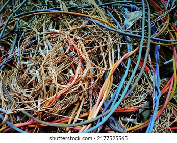 Messy pile of colorful cables network chaos of multicolor wires red, blue, yellow,black cable wires.