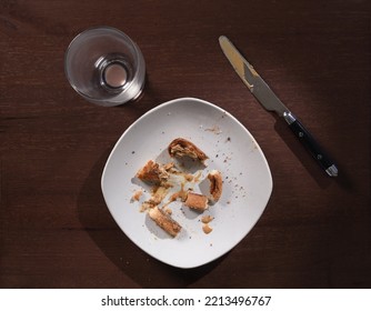 Messy Plate Of Toasted Peanut Butter Sandwich Crumbs. Overhead View.