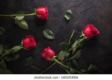 Messy Red Roses And Leaves On Black Wood Background