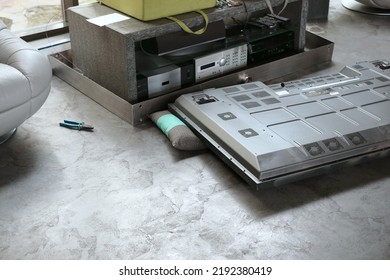 A Messy Room And Broken TV Set Abandoned Upside Down On The Floor