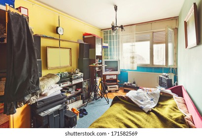 Messy room interior, a lot of different stuff, from electronic appliances and furniture to clothes.  - Shutterstock ID 171582569
