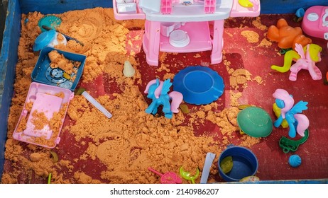 Messy Sand Box And Kid Toys Left After Kids Done Playing