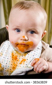 Messy Six Month Old Baby Wearing Bib After Eating Solid Food