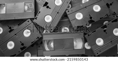 Messy stack of VHS tapes. Video Home System tape cassettes.