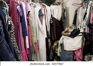 Messy Unorganized Closet Full Of Hanging Clothes