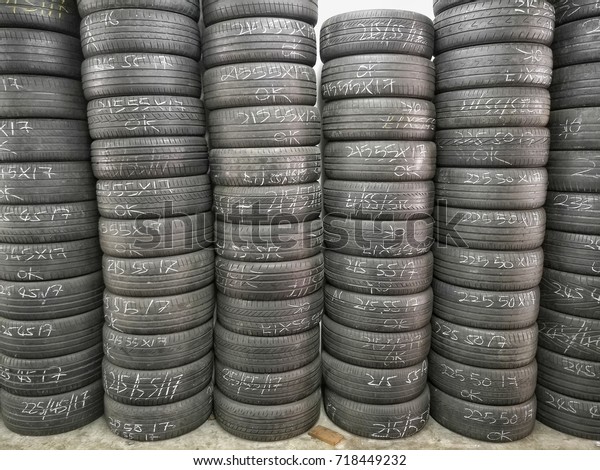 messy used tyres\
spare parts engine oil water petrol filter car jack absorbers and\
brake tools used by automotive mechanic to repair and inspect cars\
at a local workshop garage\
