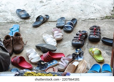 Messy Visitors Shoes on the Ground on Front of the House Door without Shoes Rack. - Shutterstock ID 2207864181