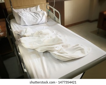 A Messy White Blanket On An Empty Patient Bed Inside The Hospital.