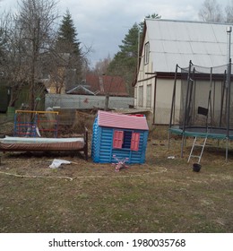 Messy Yard With A Toy House And Abandoned Furniture, Outdoor Photo