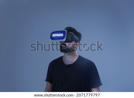 Meta Written On The Googles - Man Wearing Virtual Reality Goggles Inside A Metaverse