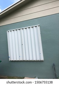 Metal Accordion Storm Shutters Closed To Protect A Home From The Oncoming Hurricane.