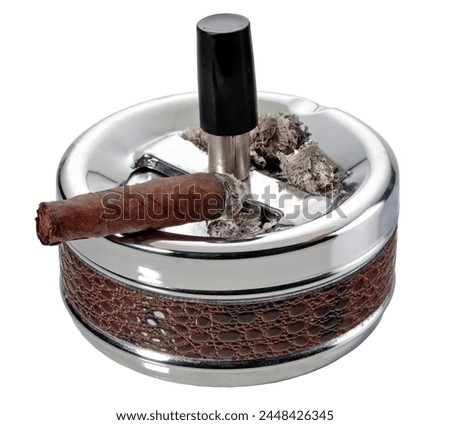Metal ashtray with a burning  well known italian cigar and ashes isolated on white background, clipping path embedded.

