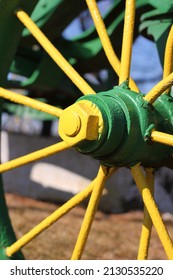 Metal Axle And Spokes Of An Antique Metal Wheel Of An Old Farm Tractor.