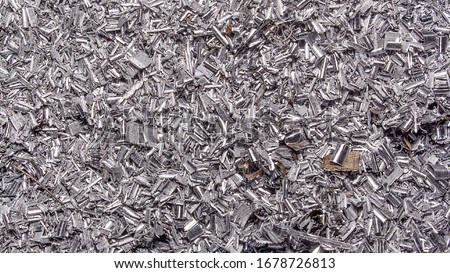 Metal background. Colored shavings. Wallpaper or screensaver of colored metallic chips.Abstract color background of metal shavings. Processing of ferrous and non-ferrous metals in a factory or plant. 