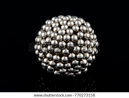metal ball made from multiple small spheres with reflection isolated on black background