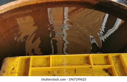 Metal Barrel Filled With Rainwater Reflection Drops