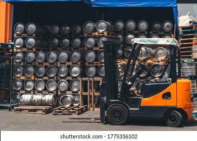 Metal barrel. Keg with beer. A large number. Stock. Logistics and alcohol concept. Wooden pallets. Car loader