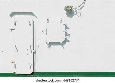 Metal Batten Down Door And Window On The Ship On White Painted Wall 