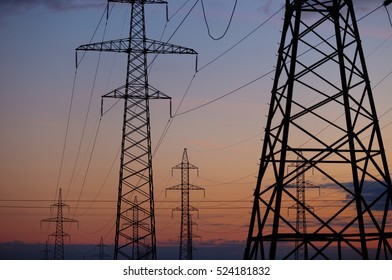 Metal Bearing High Voltage Power Line At Sunset