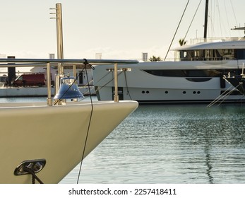 A metal bell shines on the bow of a yacht moored in a harbor. - Shutterstock ID 2257418411