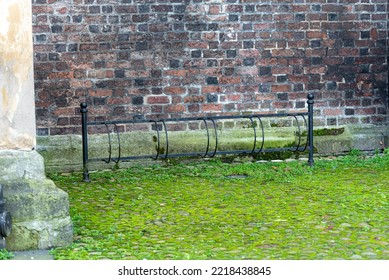 The Metal Bicycle Rack (bike Rack) In The Wall Brick Background