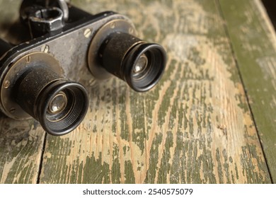 Metal binoculars on a wooden military box. Vintage old optics. - Powered by Shutterstock