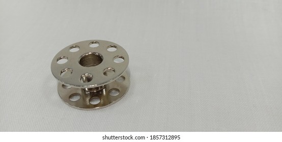 A Metal Bobbin Isolated In White Background