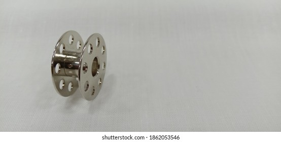 A Metal Bobbin Isolated In White Background